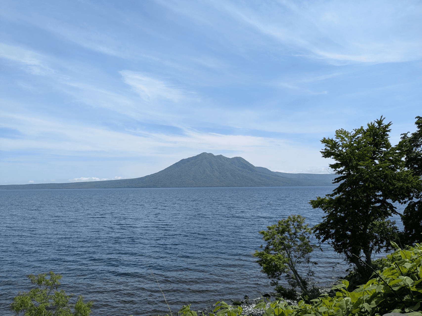 The spectacular view of Lake Shikotsu — a view you can enjoy while soaking in the hot spring.
