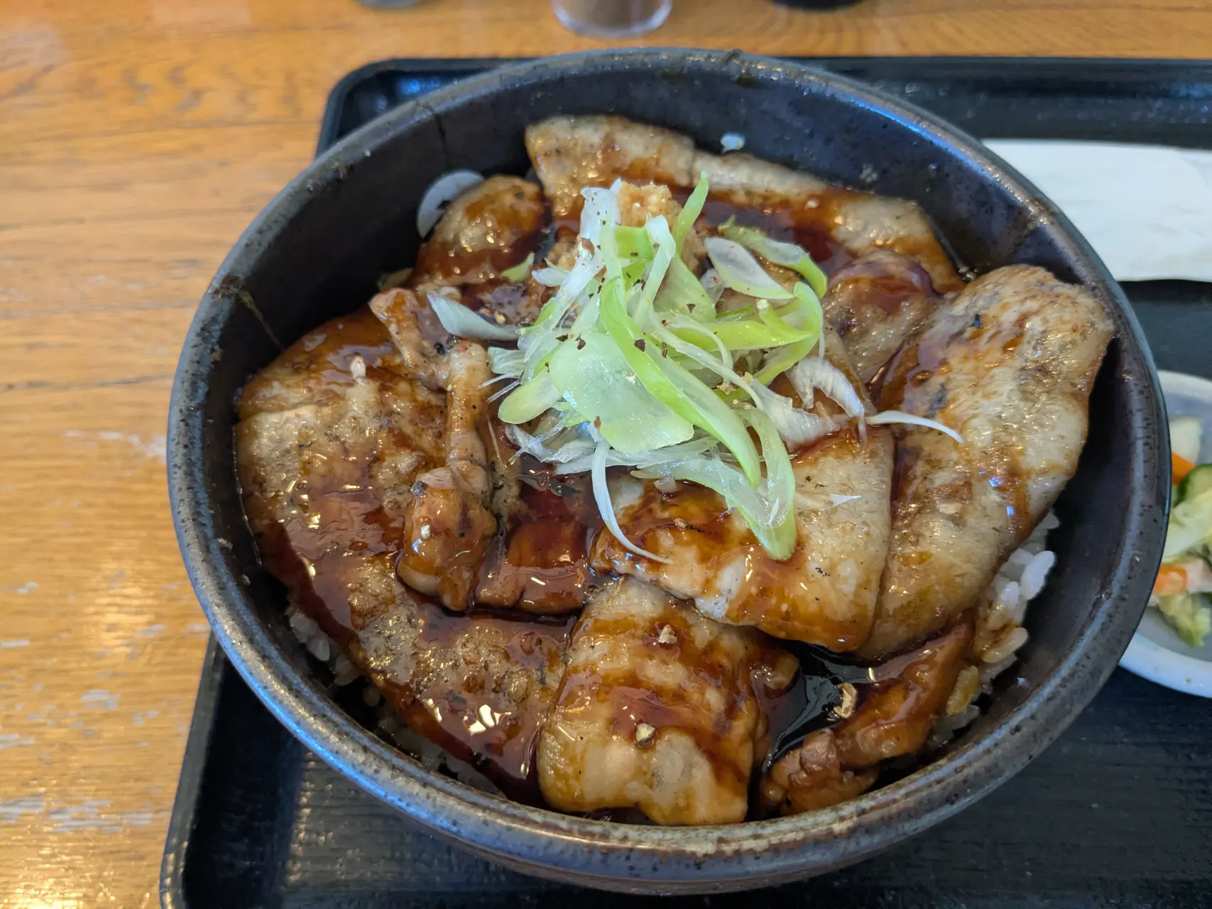 Enjoying an exquisite pork rice bowl at a shop I stumbled upon before arriving at the New Akan Hotel